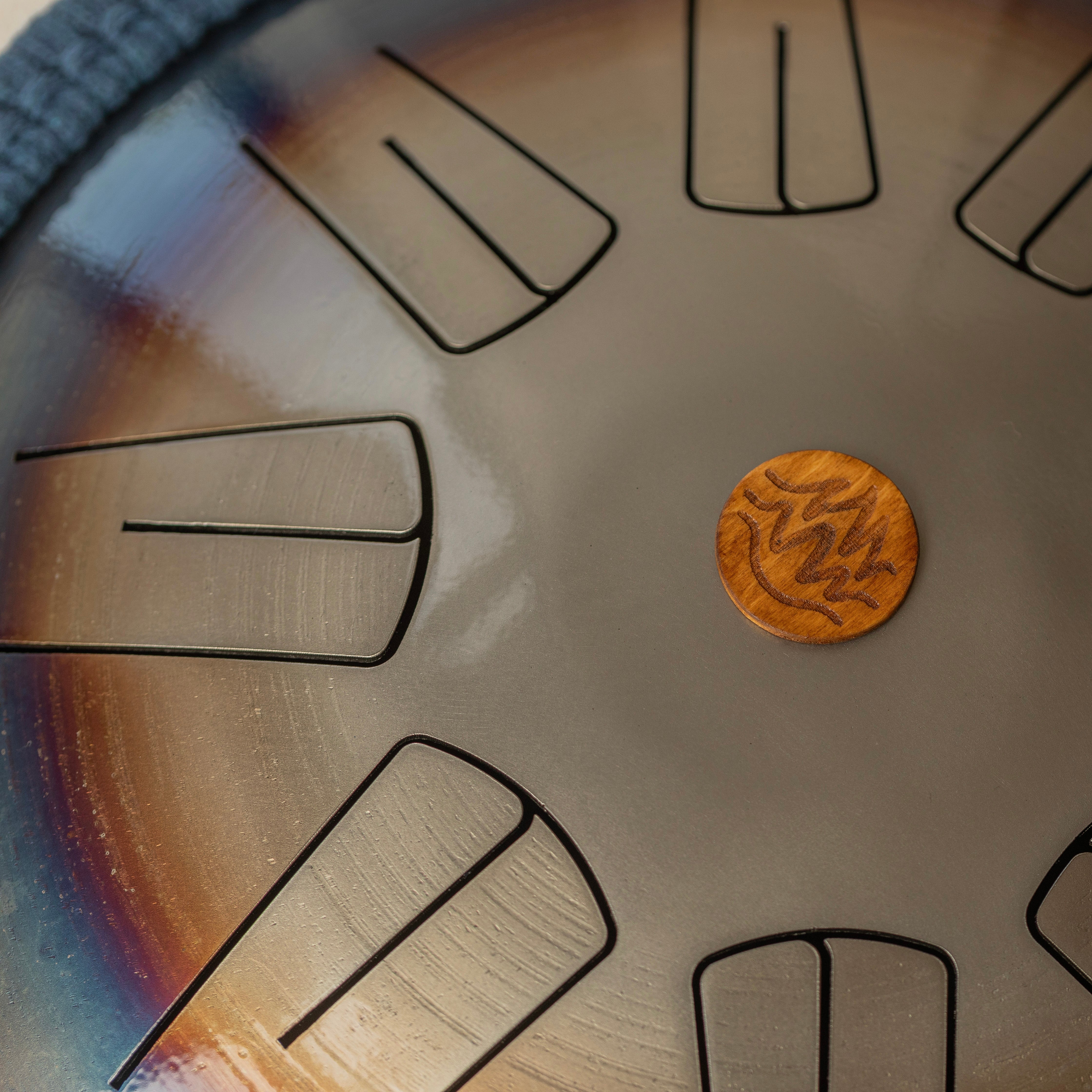 Close-up of a wooden logo Burning27 with a tongues with notes on a reflective multicolor surface