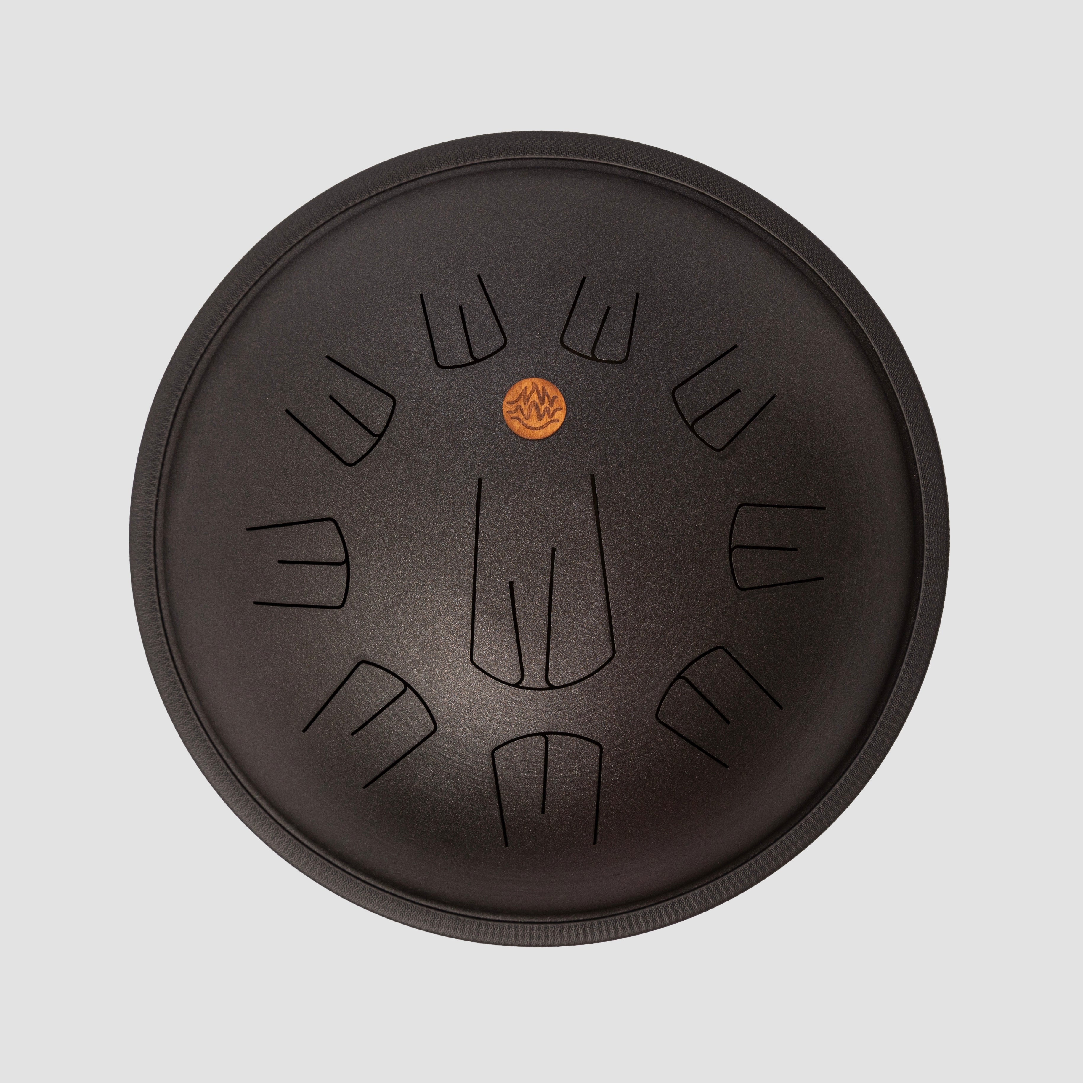 Black design tongue drum on a light gray background