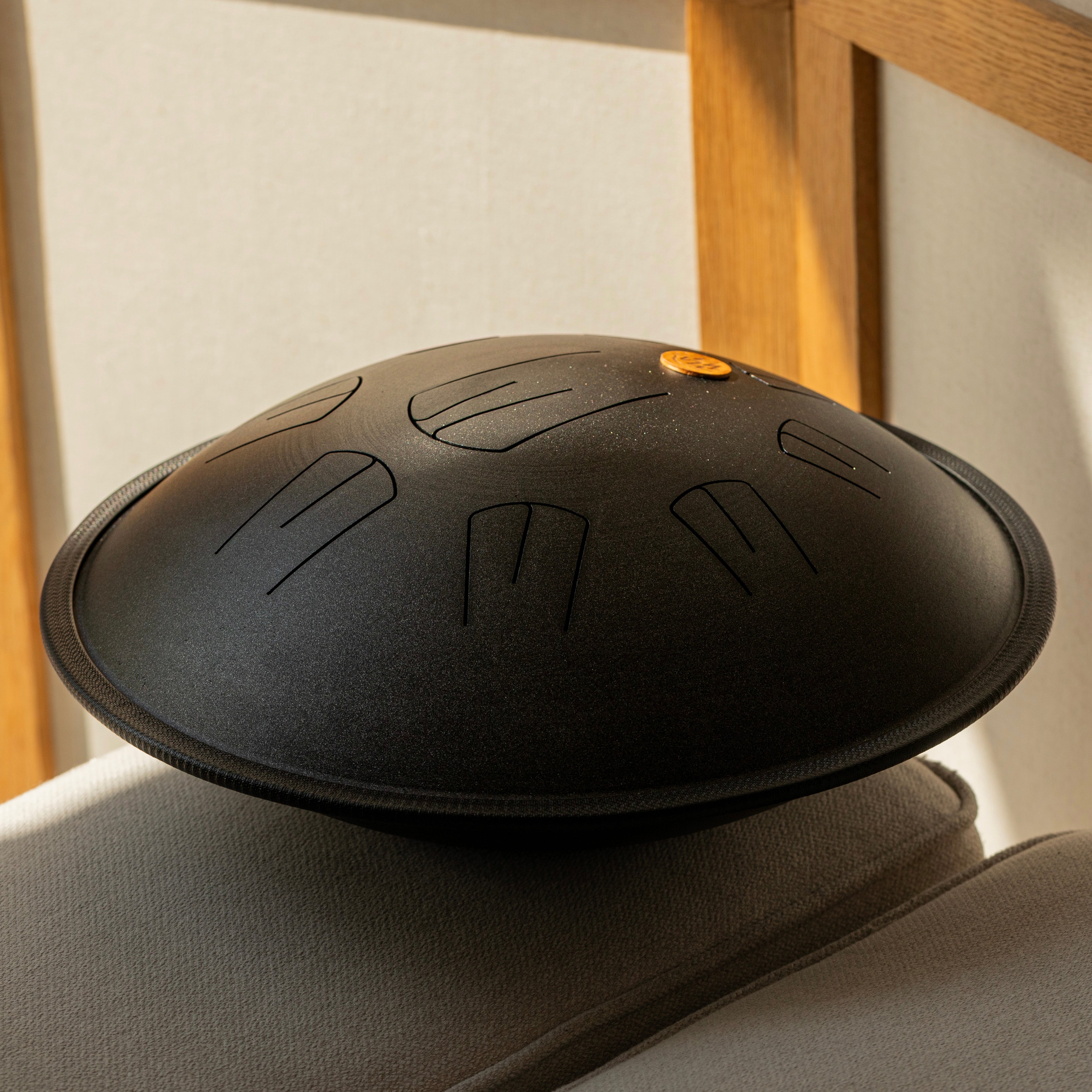 Classic handpan drum on a chair with a neutral cozy background