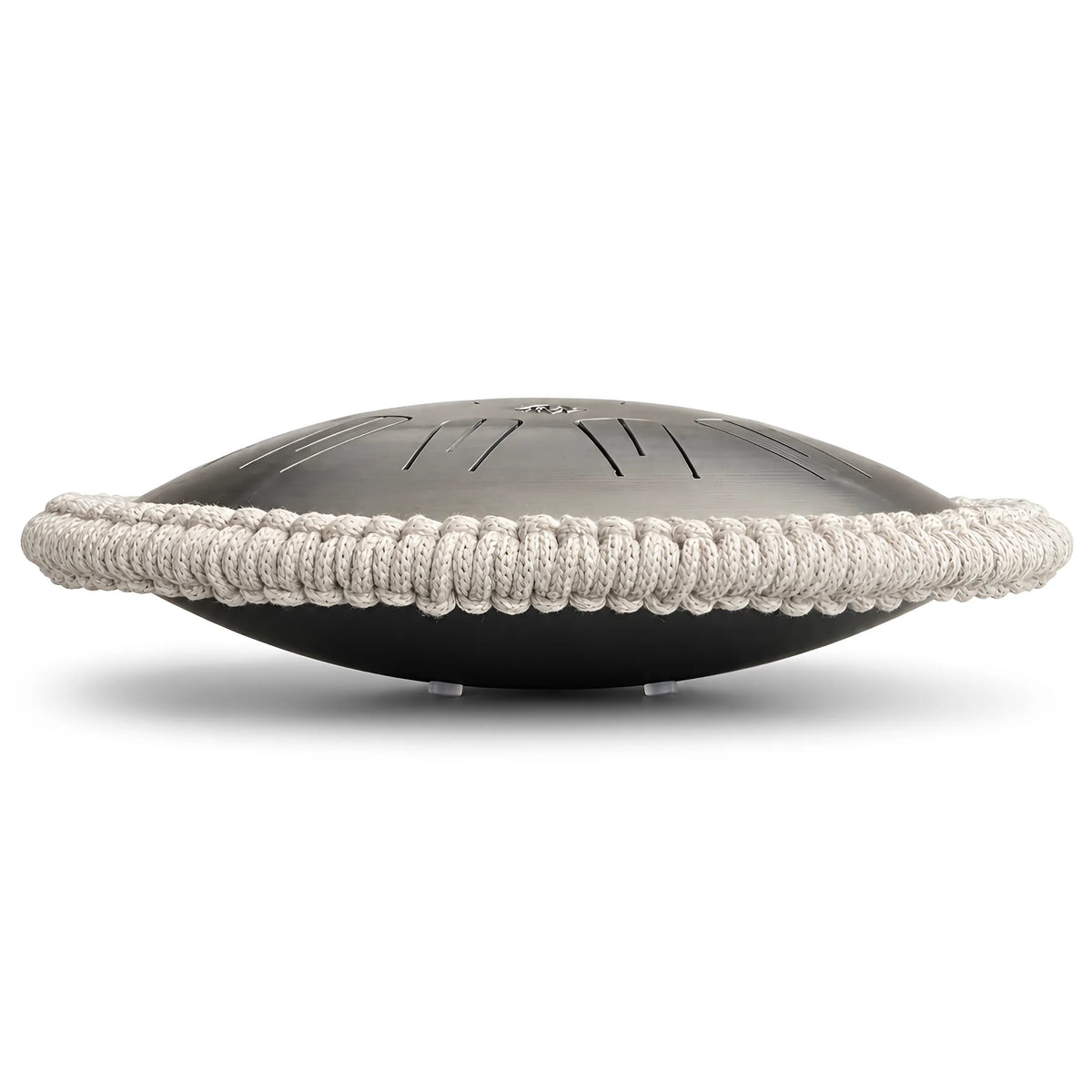Side view for a steel tongue drum in silver natural steel color with a dark gray macrame handcrafted rim, shown on a white background.